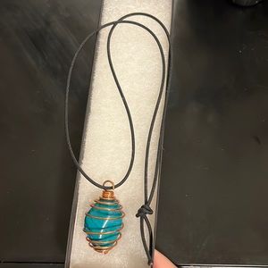 Turquoise stone wrapped in copper wire